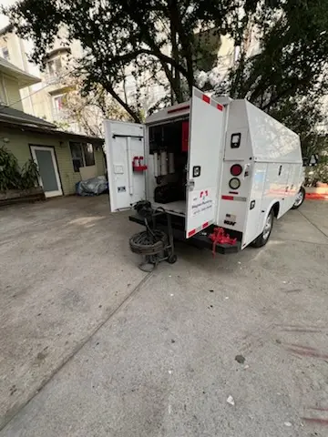 Magnet Plumbing service vehicle on-site for Grease Trap Cleaning in Le Ray